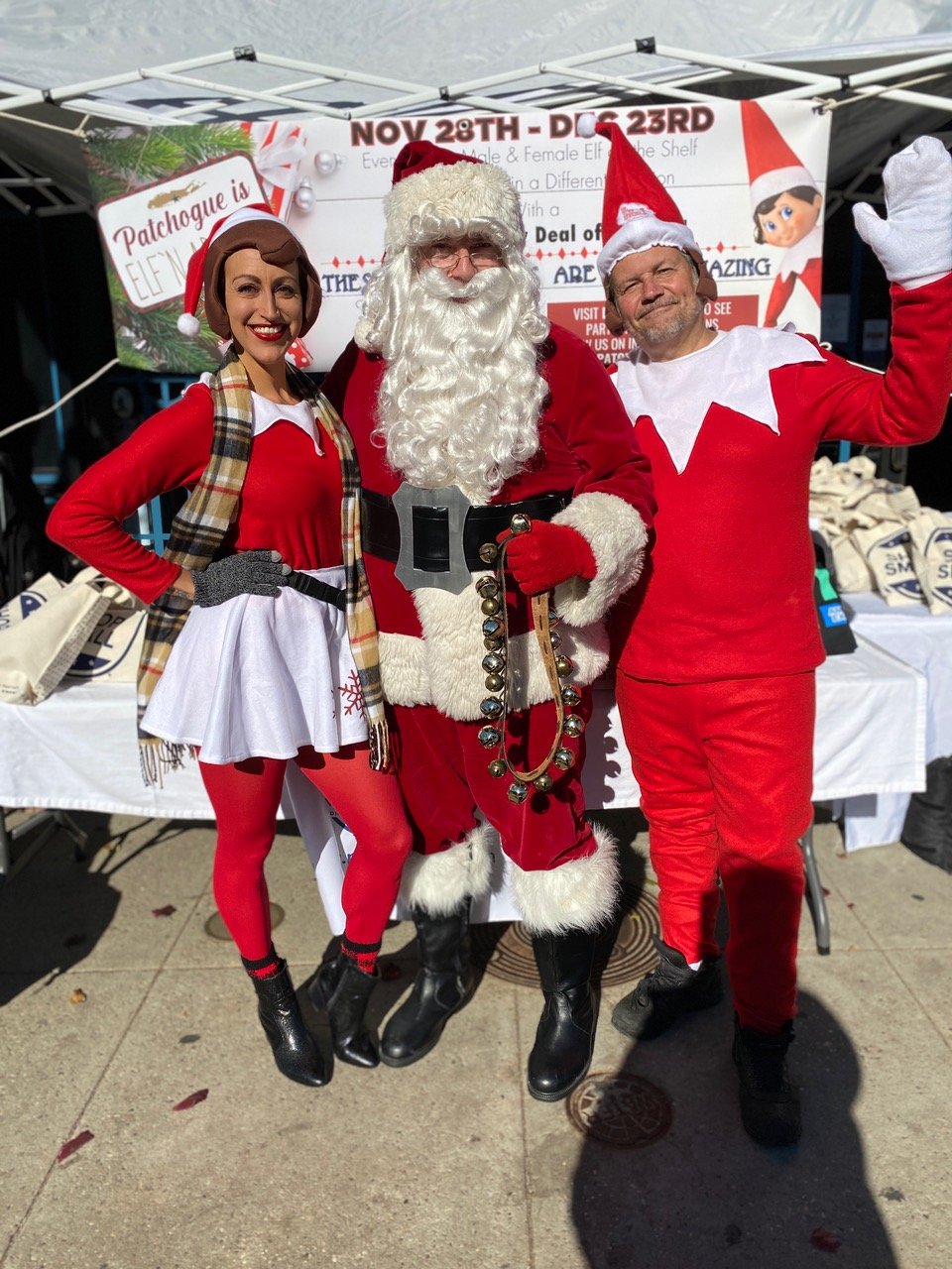 Elf David Kennedy and Elf Michele Cayea with Santa Claus.
